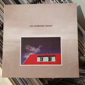 Jan Garbarek Group - Photo With Blue Sky, White Cloud, Wires, Windows And A Red Roof